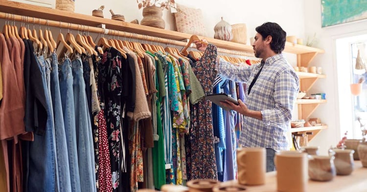 A man looks through their physical and online inventory that is located on their cloud-based product feed to ensure that all items are appropriately priced and in stock.